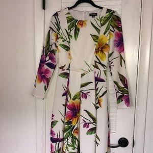 Floral long sleeve dress with pleated skirt.